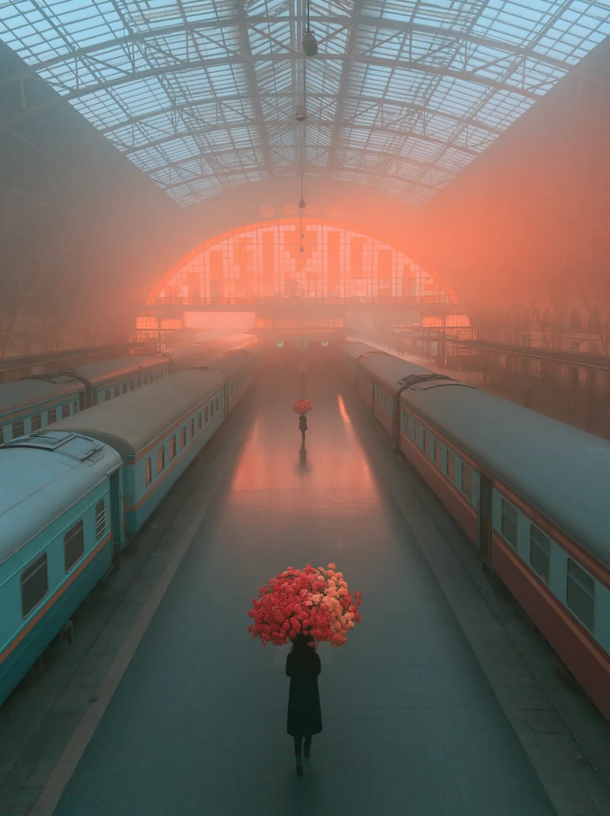 A flower carrier crossing a fog-filled train terminal in People of the Red Weather