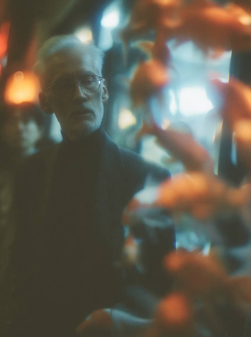 A soft-focus independent fashion portrait seen through aquarium glass and drifting orange fish